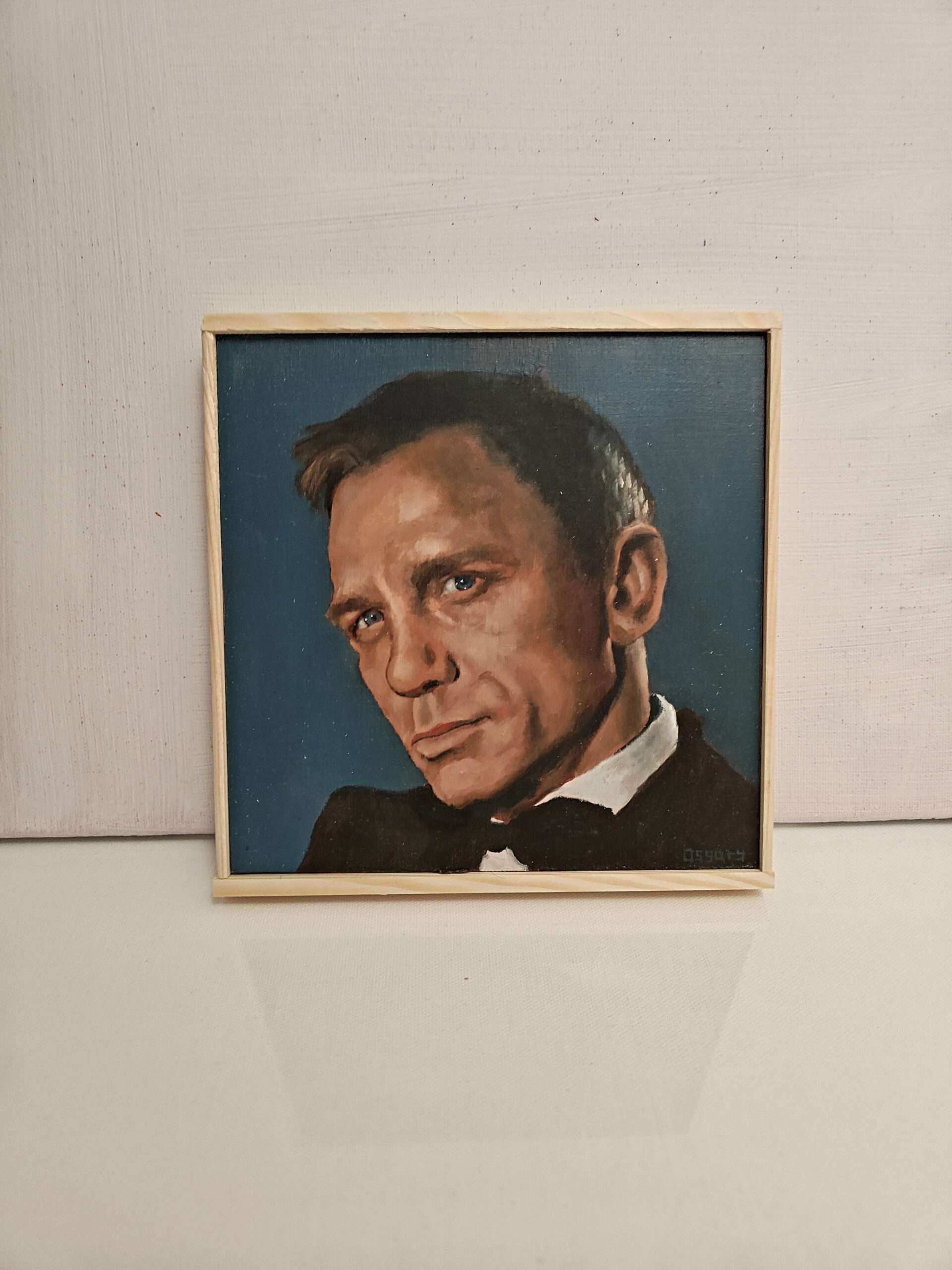 Detail of traditional oil textures on a hand-painted James Bond portrait, 8x8 inch wood panel art.
