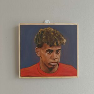 Angled side view of the Lamine Yamal football portrait showing the wood panel depth.