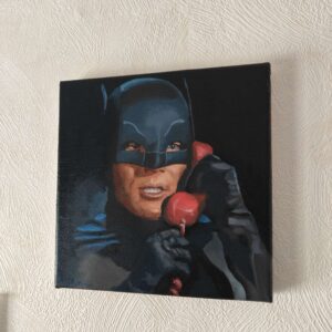 Angled view showing the deep cinematic contrast and the red Batphone on the Adam West original oil painting