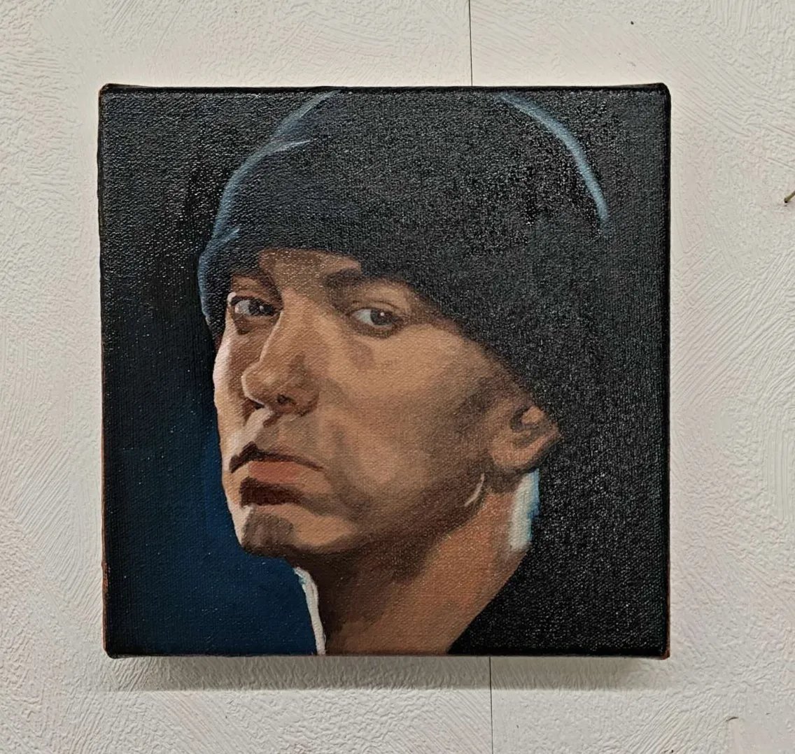 Front view of the 20x20cm Eminem original oil painting on stretched canvas capturing the rap legend in a dark beanie