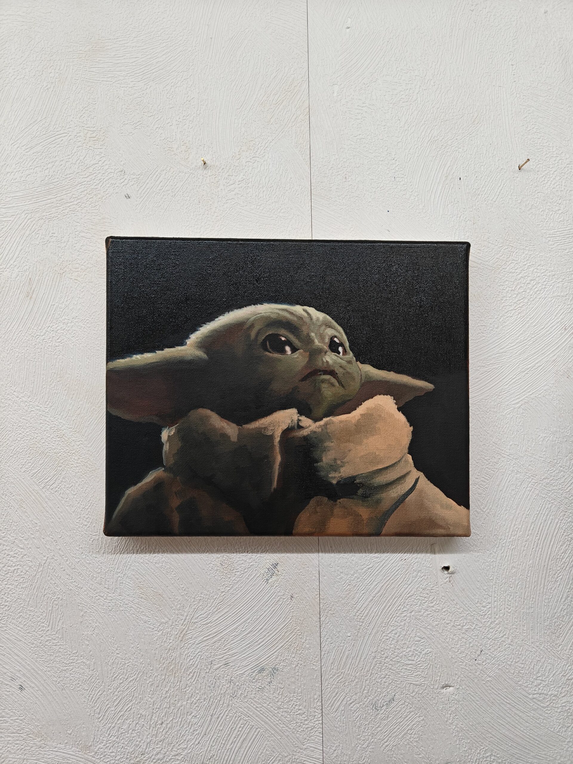 The Grogu original oil painting displayed to show the scale of this Star Wars fine art piece