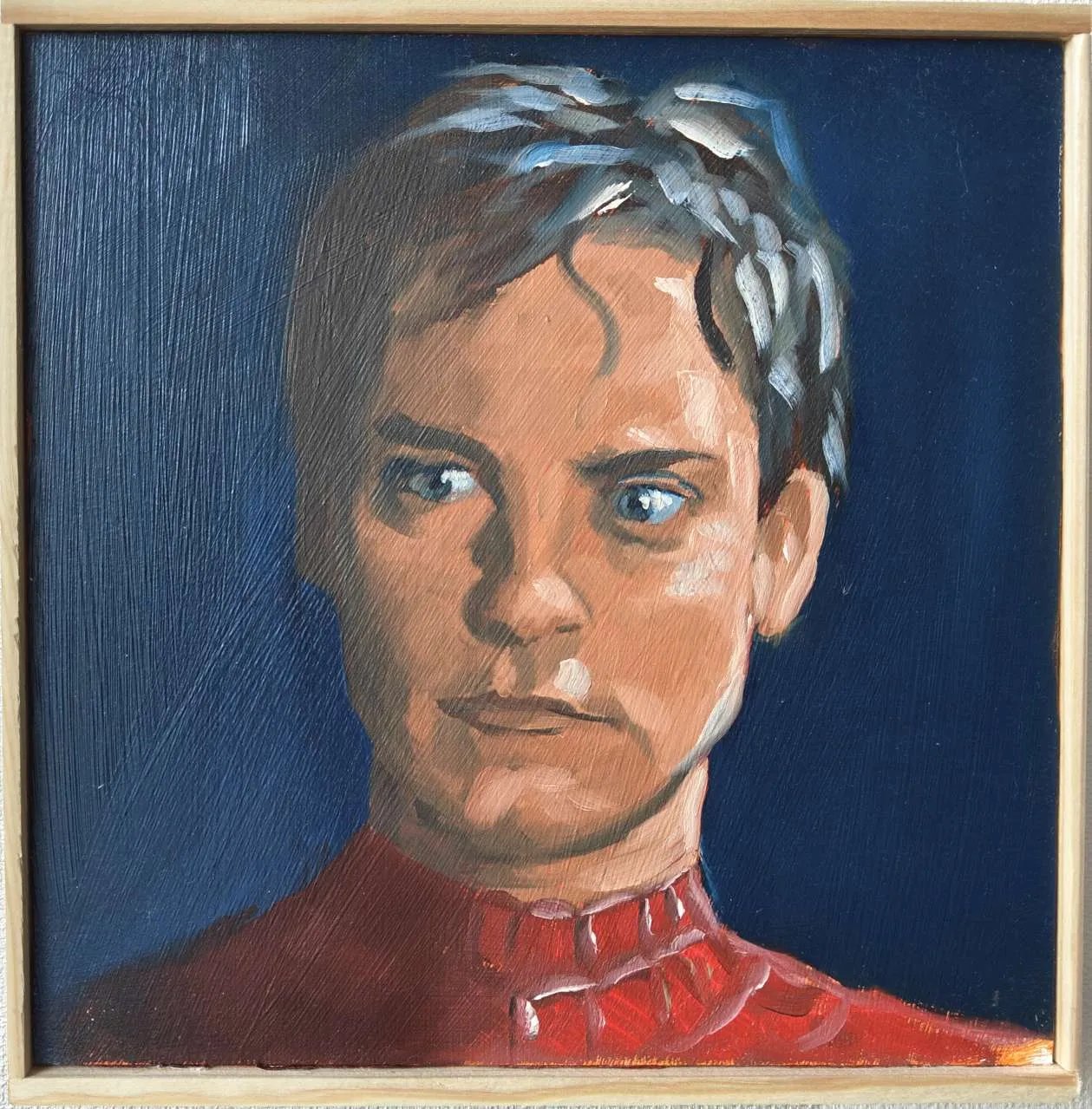 Oskari Myllymäen alkuperäinen öljyvärimaalaus Tobey Maguiresta Spider-Manin roolissa. Realistinen muotokuva Peter Parkerista punaisessa puvussa syvänsinistä taustaa vasten, maalattu puupaneelille.